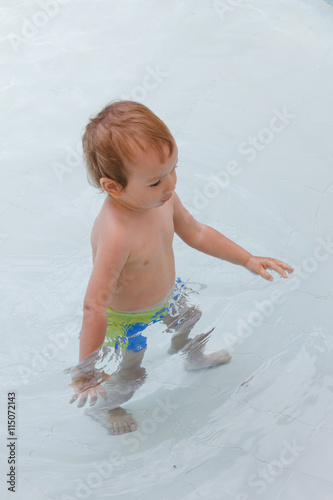 Little boy plays in the pool