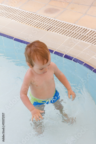 Little boy plays in the pool