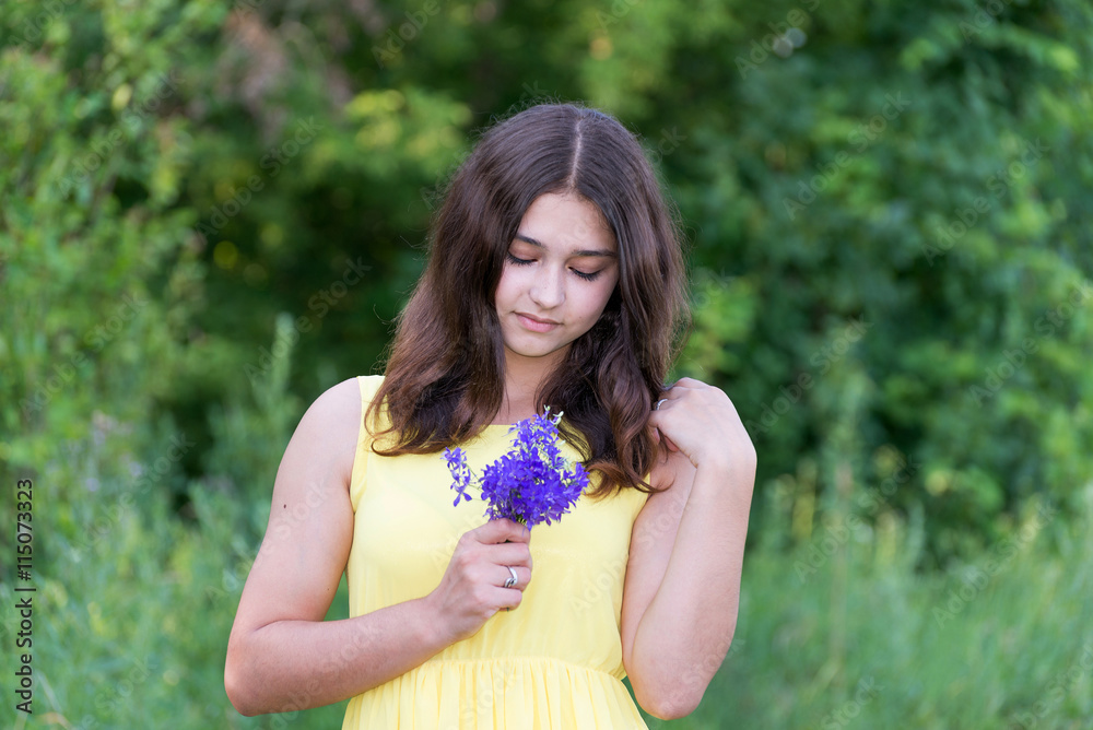 Girl with bouquet of blue wild flowers outside in summer Girl with bouquet of blue wild flowers outside in summer