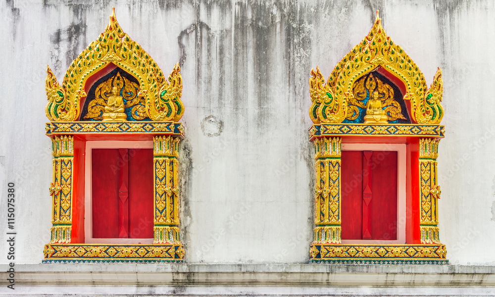The religion art of Buddhist temple windows. Exterior decoration of windows at Wat Pha Tung temple, Thailand.