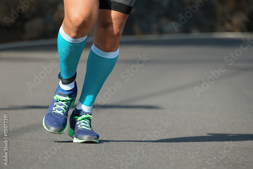 Runner on asphalt road in a marathon race