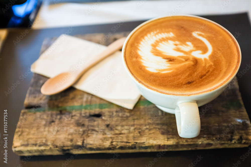 Latte art coffee cup on wooden plate Latte art coffee cup on wooden plate