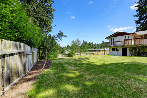 Spacious backyard area with wooden fence