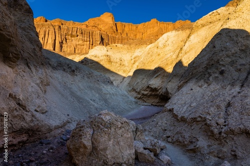 Red Cathedral seen from the Golden Canyon trail. Narrow canyon with vertical walls on both sides. Rocky landscape background. Golden Canyon trail  Death Valley National Park