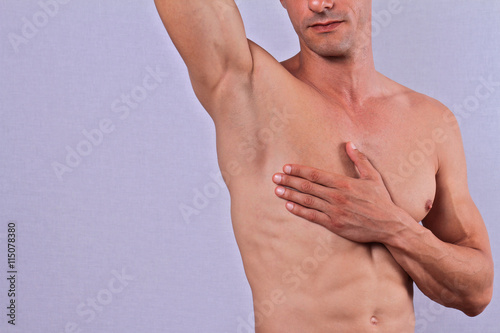 Body Waxing For Man . Attractive male body , Muscular torso, Chest and underarms hair removal close up.