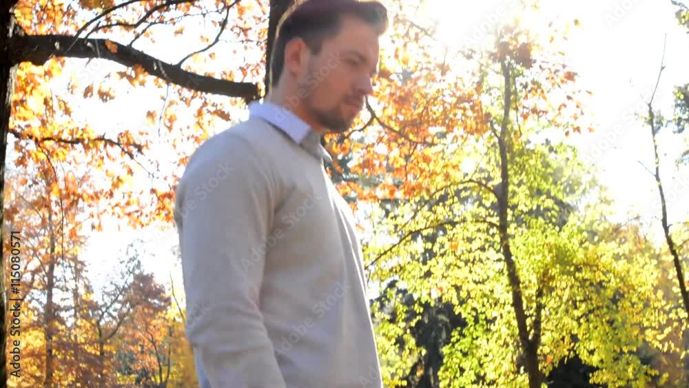 Young handsome man goes through the woods and over his head shine rays Young handsome man goes through the woods and over his head shine rays
