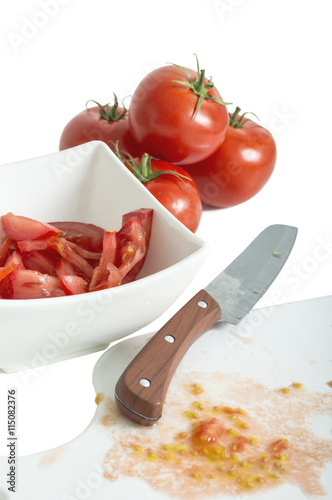 Chopped tomatoes and knife on cutting board
