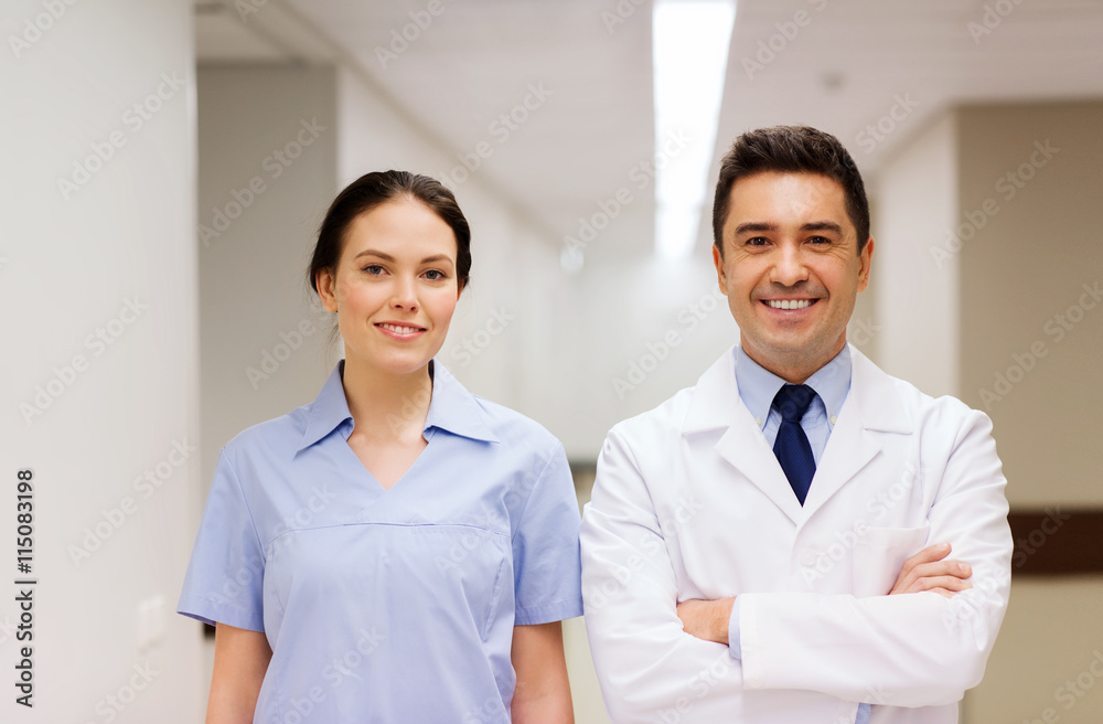 smiling doctor in white coat and nurse at hospital smiling doctor in white coat and nurse at hospital