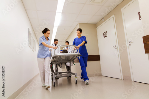 medics with woman on hospital gurney at emergency