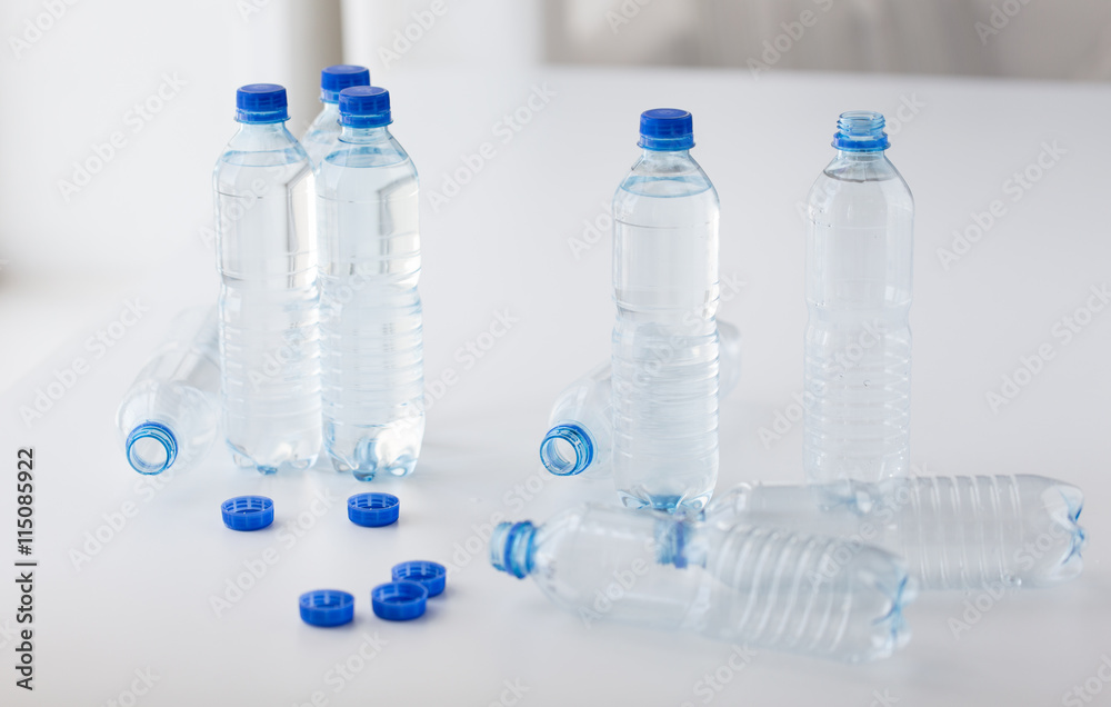 close up of bottles with drinking water on table close up of bottles with drinking water on table