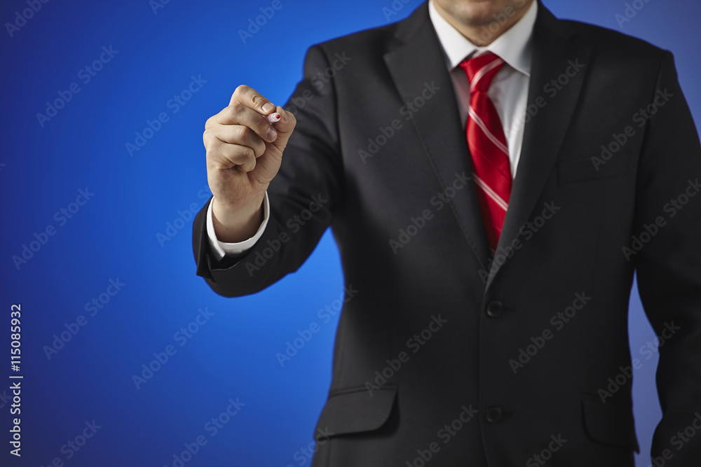 Businessman writing, drawing on the screen on a blue background Businessman writing, drawing on the screen on a blue background