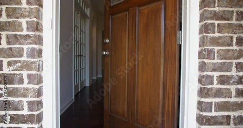 Front Home Entrance Door Open Rise Up. rising shot of the front entrance as the door opens to reveal the hallway of a modern residential home 
