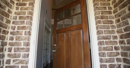 Front Home Entrance Low Angle Door Open Rise Up. rising low angle shot of the front entrance as the door opens to reveal the hallway of a modern residential home 
