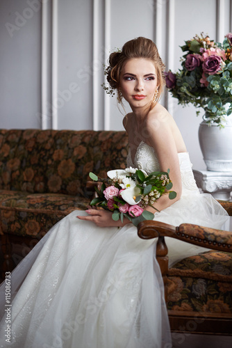 Young attractive bride with flowers
