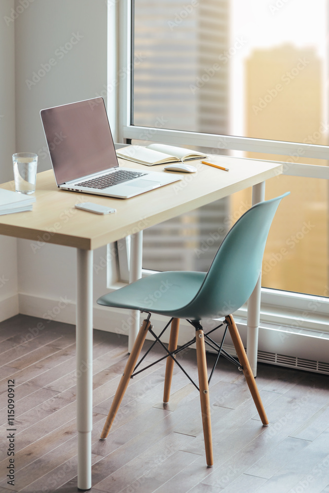 Workplace photographer, Modern desktop in loft, Wooden desk with modern chair, Desktop with modern laptop, glass of water, modern smartphone, notebook. View of downtown, Sunrise, Shallow DOF. Workplace photographer, Modern desktop in loft, Wooden desk with modern chair, Desktop with modern laptop, glass of water, modern smartphone, notebook. View of downtown, Sunrise, Shallow DOF.