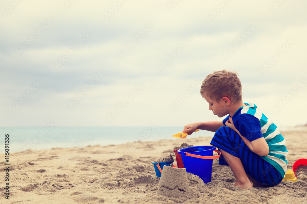 little boy play with sand on beach little boy play with sand on beach