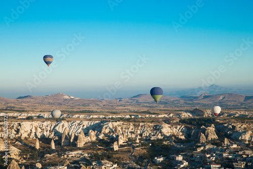  air balloons flying over the valley at Cappadocia