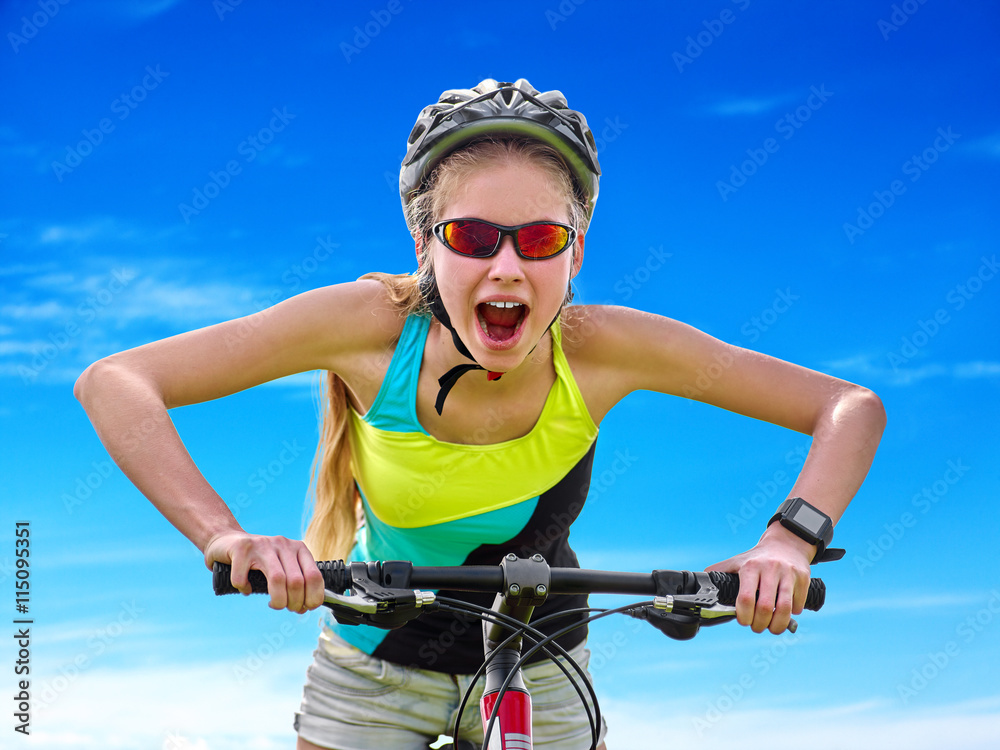 Bikes cycling girl. Girl rides bicycle against blue sky with loud cry. Girl in cycling. Cycling is good for health. Cyclist looking up on blue sky. Bikes cycling girl. Girl rides bicycle against blue sky with loud cry. Girl in cycling. Cycling is good for health. Cyclist looking up on blue sky.