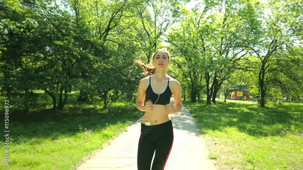 Athletic woman running outdoors. Young woman jogging at park. Action and healthy lifestyle concept. Athletic woman running outdoors. Young woman jogging at park. Action and healthy lifestyle concept.
