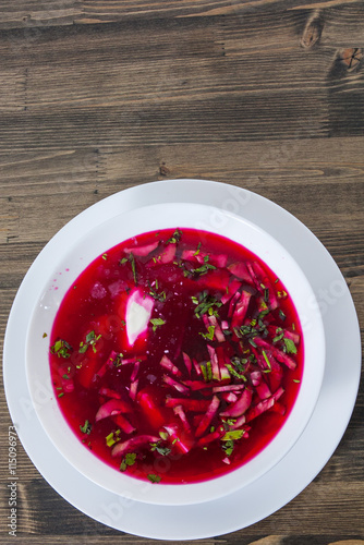 Vegetable cold soup with beet, cucumber, radsih and egg  on wooden table photo