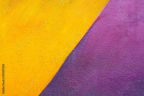 Colorful (yellow and purple) brick wall as background, texture