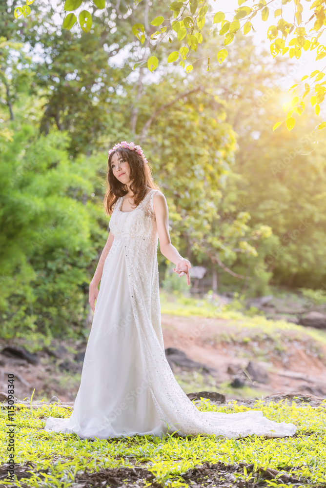 beautiful young woman in white dress with flower on her hair hol beautiful young woman in white dress with flower on her hair hol
