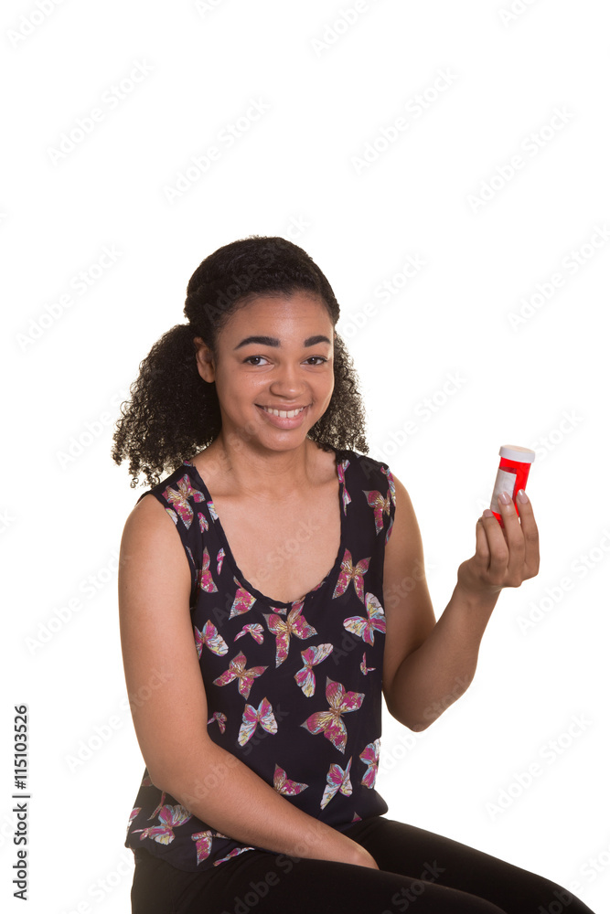 Young woman holding and reading the label on a pill bottle Young woman holding and reading the label on a pill bottle