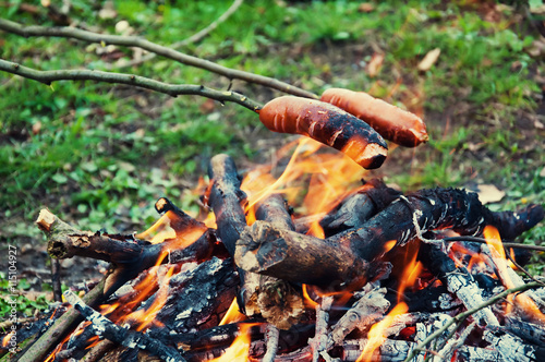 Roasting sausages over the fire