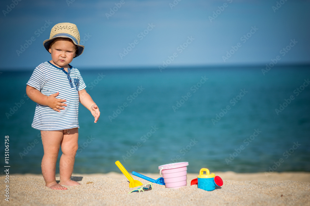 Cute baby on the tropical beach playing toys Cute baby on the tropical beach playing toys