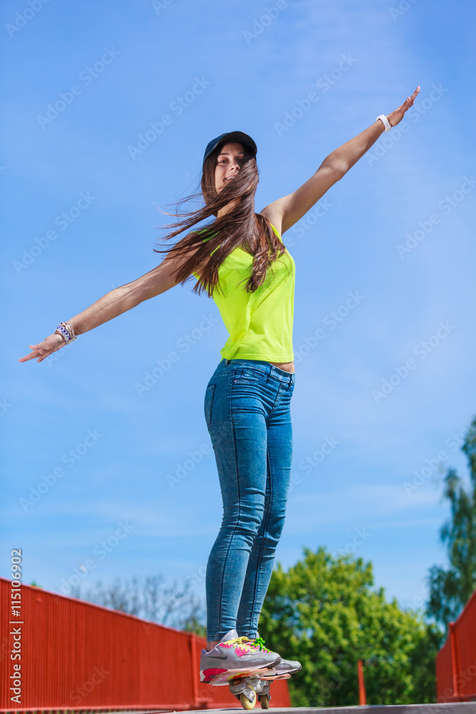 Teen girl skater riding skateboard on street. Teen girl skater riding skateboard on street.