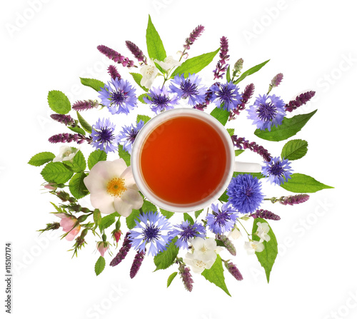 Fototapeta Naklejka Na Ścianę i Meble -  Cup of tea with fresh flowers lying around on white background