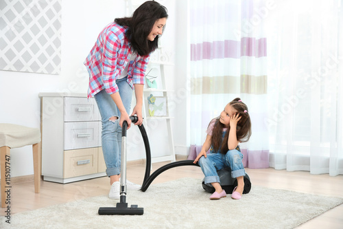 Daughter and mother using v...