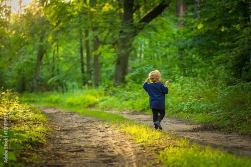 Small blonde boy playing in forest © milosz_g