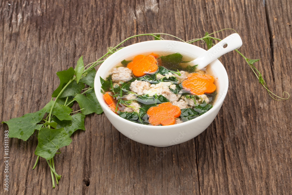 soup with pork and gourd on wooden background soup with pork and gourd on wooden background