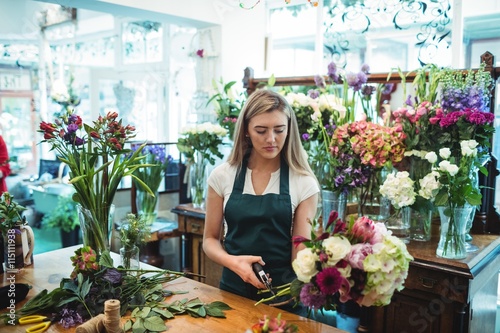 Female florist trimming flower stem photo