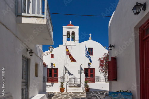 White orthodox church and small bell tower in Mykonos, Cyclades Islands, Greece