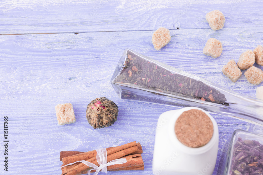 dry tea leaves cinnamon and on wooden background