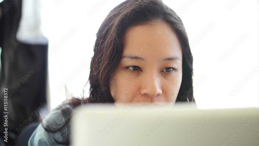 Portrait of Asian freelance business woman using a laptop computer working from home Portrait of Asian freelance business woman using a laptop computer working from home