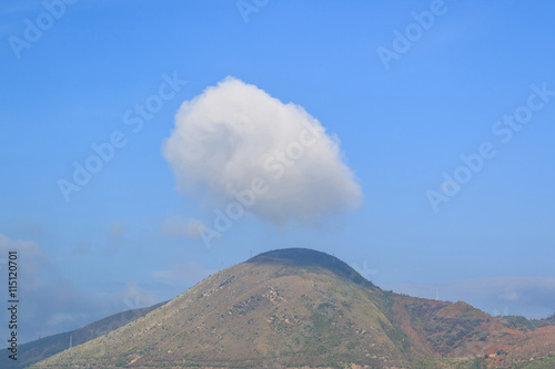 Wonderful view of big fluffy cloud over top of mountain.