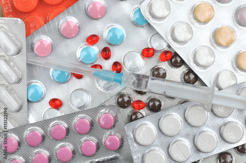 Many Pills, Drugs, Tablets and Syringe on table Many Pills, Drugs, Tablets and Syringe on table