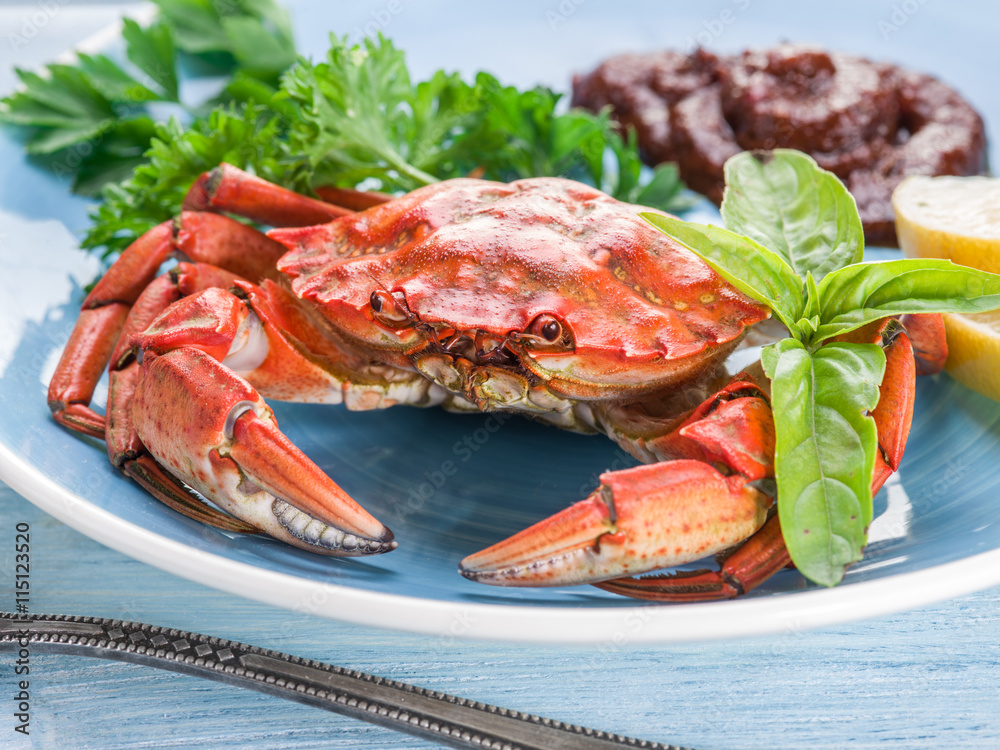 Cooked crab with lemon and herbs. Stock Photo Adobe Stock