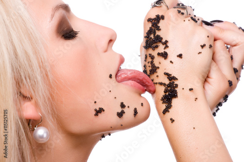 Woman eat black caviar