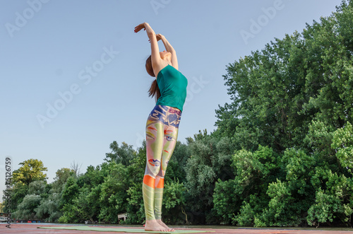 girl practicing yoga outside