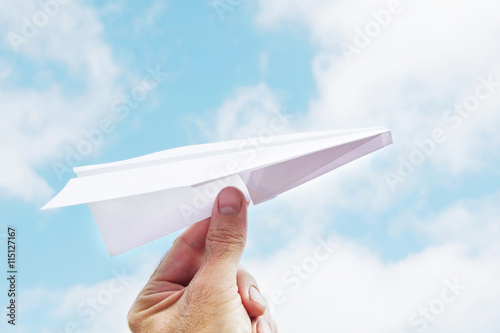 Man throws a paper plane to sky