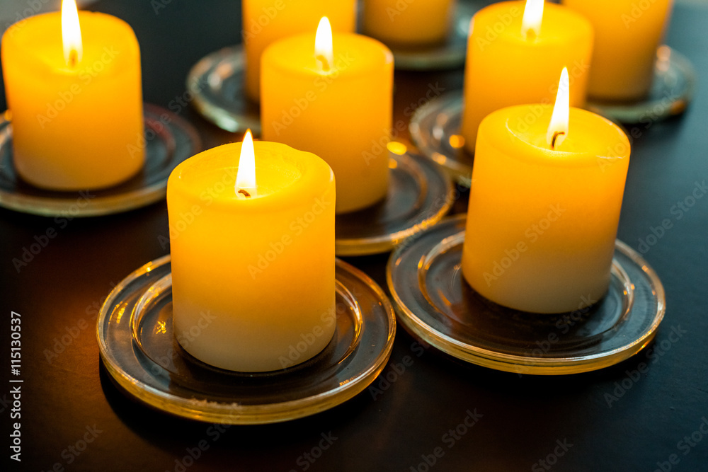 closeup to burning candles in darkness closeup to burning candles in darkness