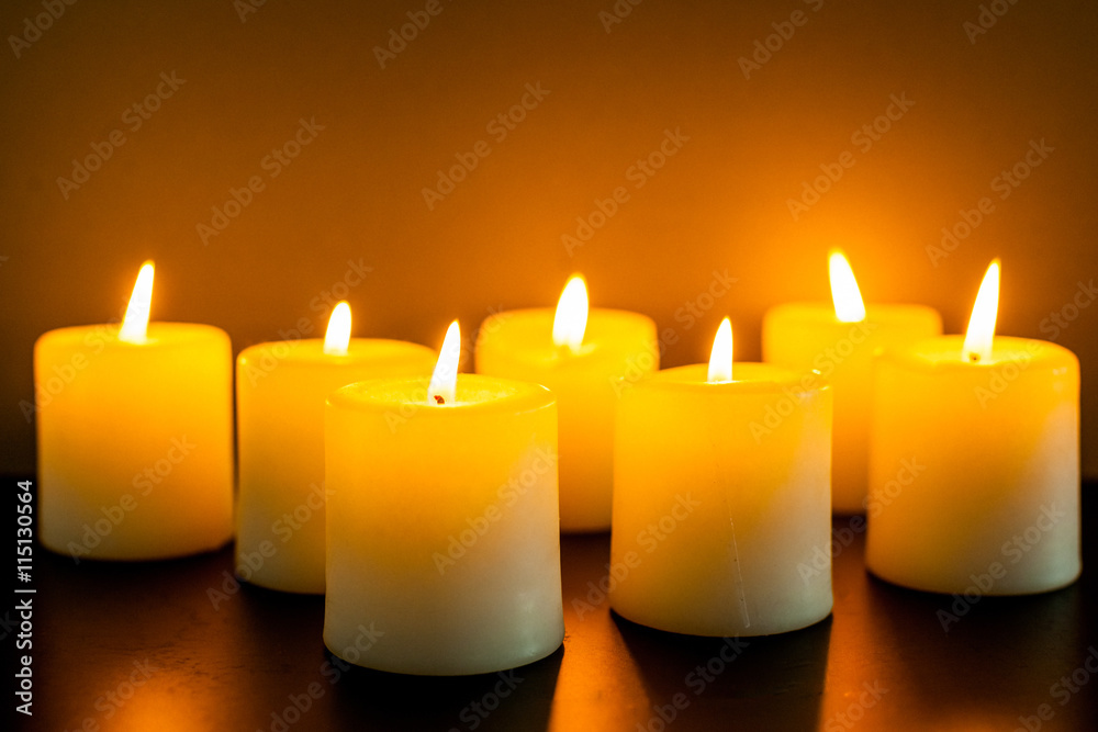 closeup to burning candles in darkness closeup to burning candles in darkness