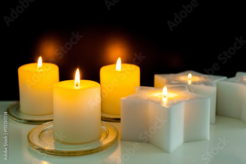closeup to burning candles in darkness