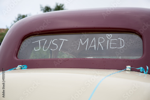 Just Married written on the trunk of a red car © OceanProd