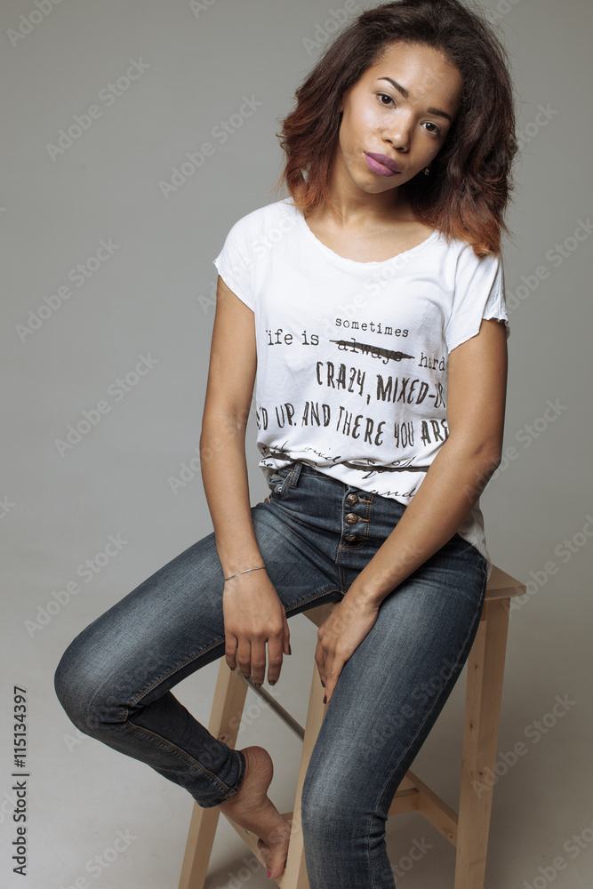 Elegant beautiful African American woman sitting in a contemporary ...