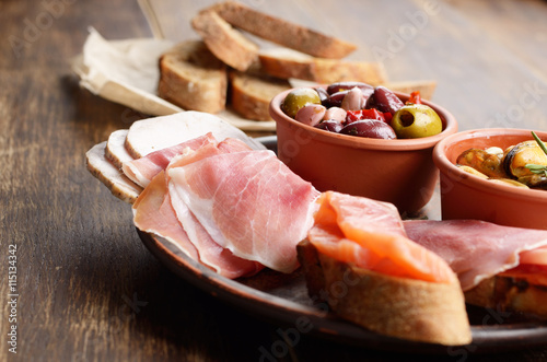 Tapas of salmon, mussels, jamon and olives